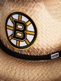Load image into Gallery viewer, A close up of the front of the Boston Bruins straw cowboy hat. Visible is the team logo, the black rope surrounding the crown of the hat, and the Calhoun Surf &amp; Skate logo.

