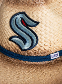 Load image into Gallery viewer, A close up of the front of the Seattle Kraken straw cowboy hat. Visible is the team logo, the navy rope surrounding the crown of the hat, and the Calhoun Surf &amp; Skate logo.
