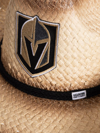 Load image into Gallery viewer, A close up of the front of the Vegas Golden Knights straw cowboy hat. Visible is the team logo, the black rope surrounding the crown of the hat, and the Calhoun Surf &amp; Skate logo.
