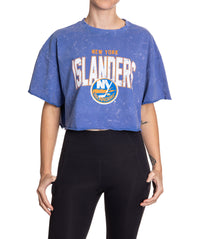 Load image into Gallery viewer, Woman standing in front of a white background wearing an oversized, blue, acid wash crop top - featuring a New York Islanders logo in the center of the shirt.
